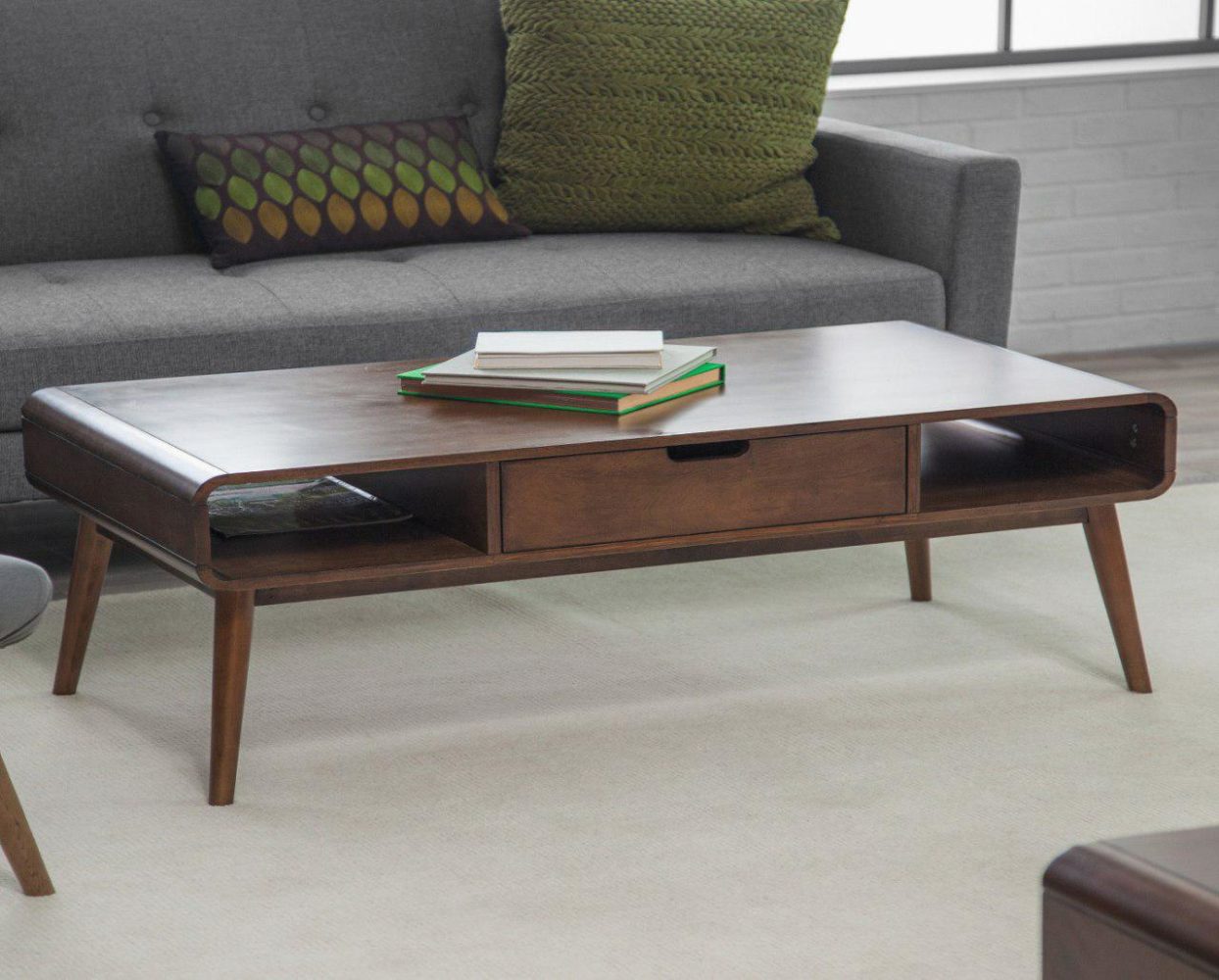 Wooden coffee table with books and sofa - Taskmasters Dubai